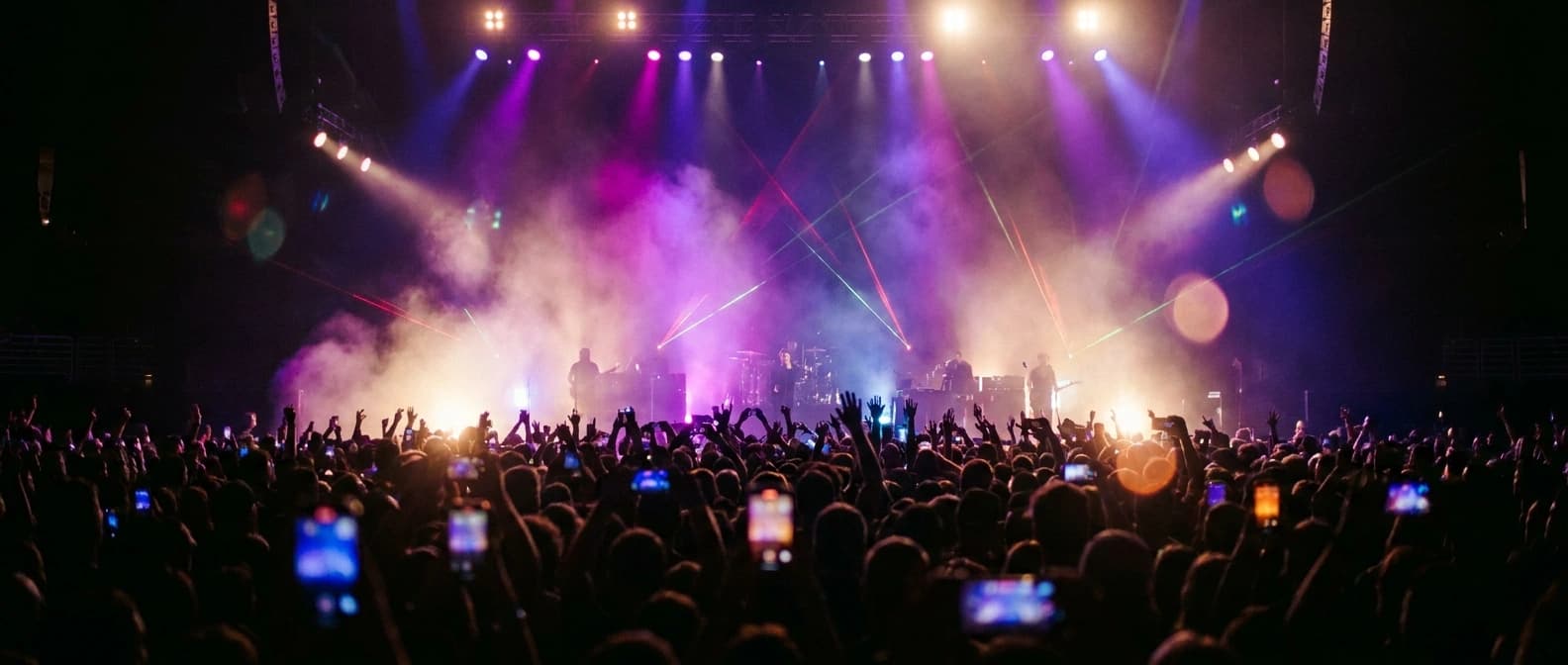 Concert stage lights and crowd from the audience POV